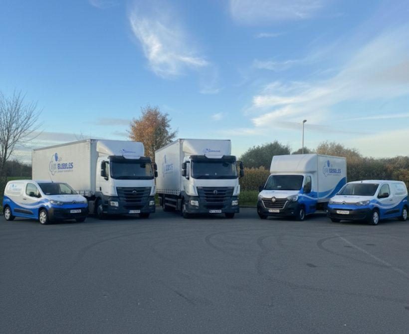 Five Mr Bubbles vans and trucks lined up on the depot yard.